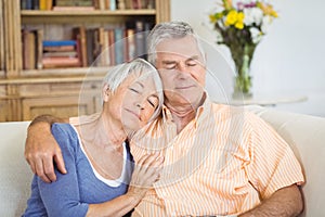 Senior couple relaxing on sofa in living room