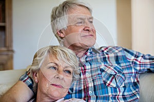 Senior couple relaxing on sofa in living room