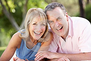 Senior Couple Relaxing In Summer Garden