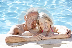 Senior Couple Relaxing In Swimming Pool Together