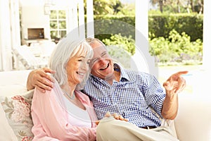 Senior Couple Relaxing Together On Sofa