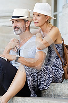 senior couple relaxing while visiting city