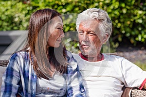 Senior couple resting and sunbathing in garden