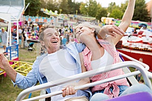 Senior couple on a ride in amusement park