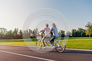 Senior couple riding bicycle