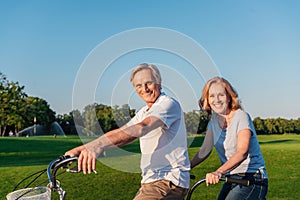 Senior couple riding bicycle