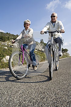 Senior couple riding a bike