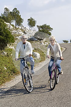 Senior couple riding a bike