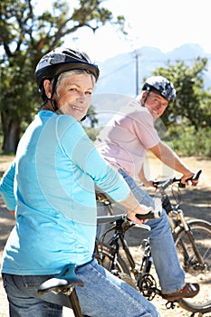 Senior couple riding bikes having fun