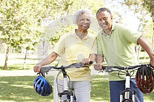 Senior Couple Riding Bikes In Park