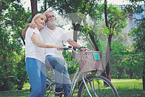 Senior Couple Riding Bikes In Park