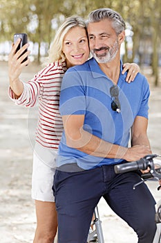 senior couple riding their bicycle in city center