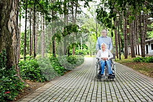 Senior couple rolling and strolling in the park