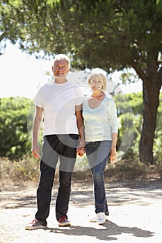 Senior Couple On Romantic Walk In Countryside