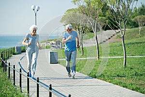 Senior Couple Running Outdoors