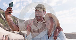 Senior couple, selfie and beach with peace hand sign and happiness outdoor on holiday. Summer travel, happy people and