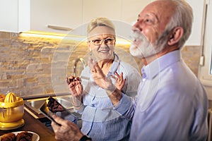 Senior couple shopping online with tablet and credit card