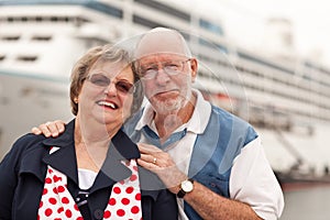 Senior Couple On Shore in Front of Cruise Ship