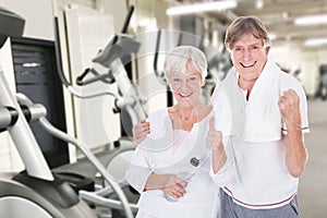 Senior Couple Showing Thumb Up Gesture At Gym