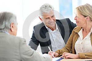 Senior couple signing real-estate contract