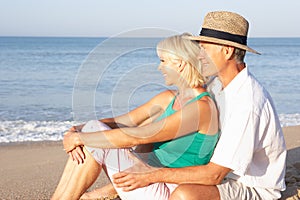 Senior couple sitting on beach relaxing