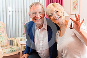 Senior couple sitting on bed in hotel room