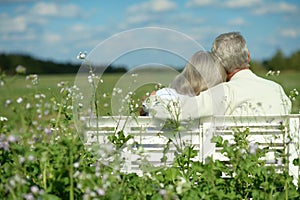 Senior couple sitting on bench