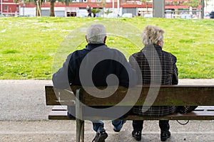 Senior couple sitting on bench from behind