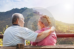 Senior couple sitting on the bench in nature park