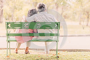 Senior couple sitting on the bench in the park