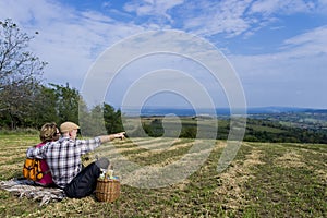 Senior couple sitting in the field