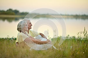 Senior couple sitting on grass