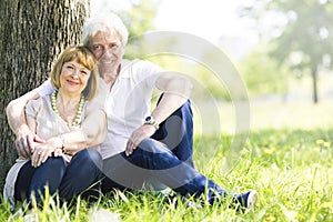 Senior couple sitting on grass