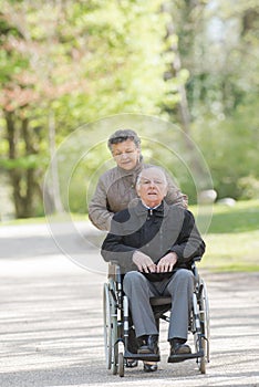 senior couple sitting on grass together relaxing