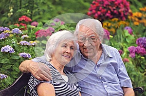 Senior couple sitting happily in their garden