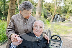 Senior couple sitting outdoors on park bench