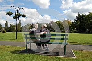 Senior couple sitting on a park bench