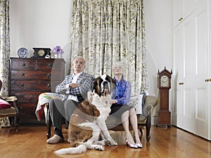 Senior Couple Sitting With Their Pet Dog