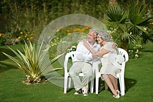 Senior couple sitting at tropic garden
