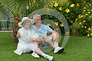 Senior couple sitting at tropic garden