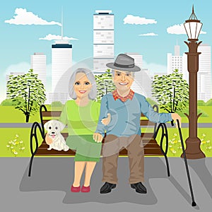 Senior couple sitting on wooden bench with dog resting in city park