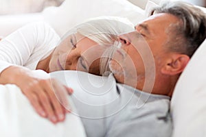 Senior couple sleeping in bed