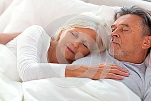 Senior couple sleeping in bed