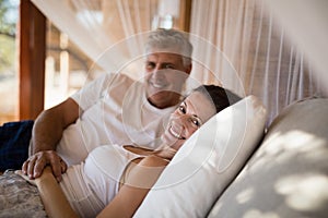 Senior couple sleeping on canopy bed