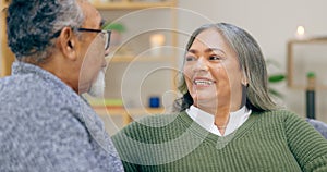 Senior couple, smile and conversation in home living room, love and bonding together to relax. Happy elderly man, woman