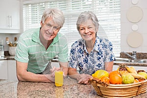 Senior couple smiling at the camera together