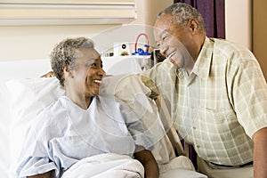 Senior Couple Smiling At Each Other In Hospital