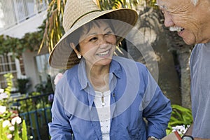 Senior couple smiling outdoors (close-up)