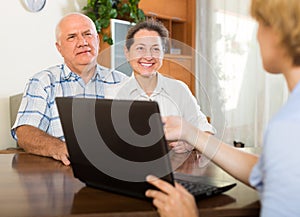 Senior couple with social worker at home