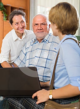 Senior couple with social worker at home